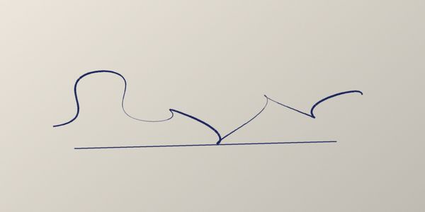 A signature photographed on cream paper, with shadow across the page